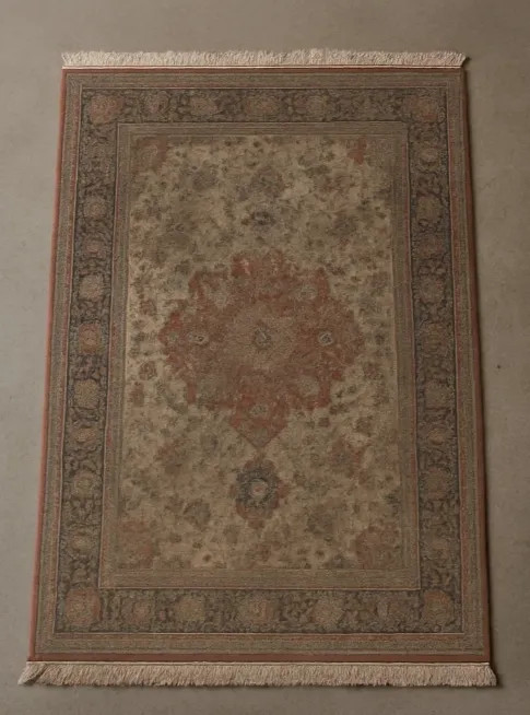 A faded and stained Persian rug before professional cleaning in Sydney.